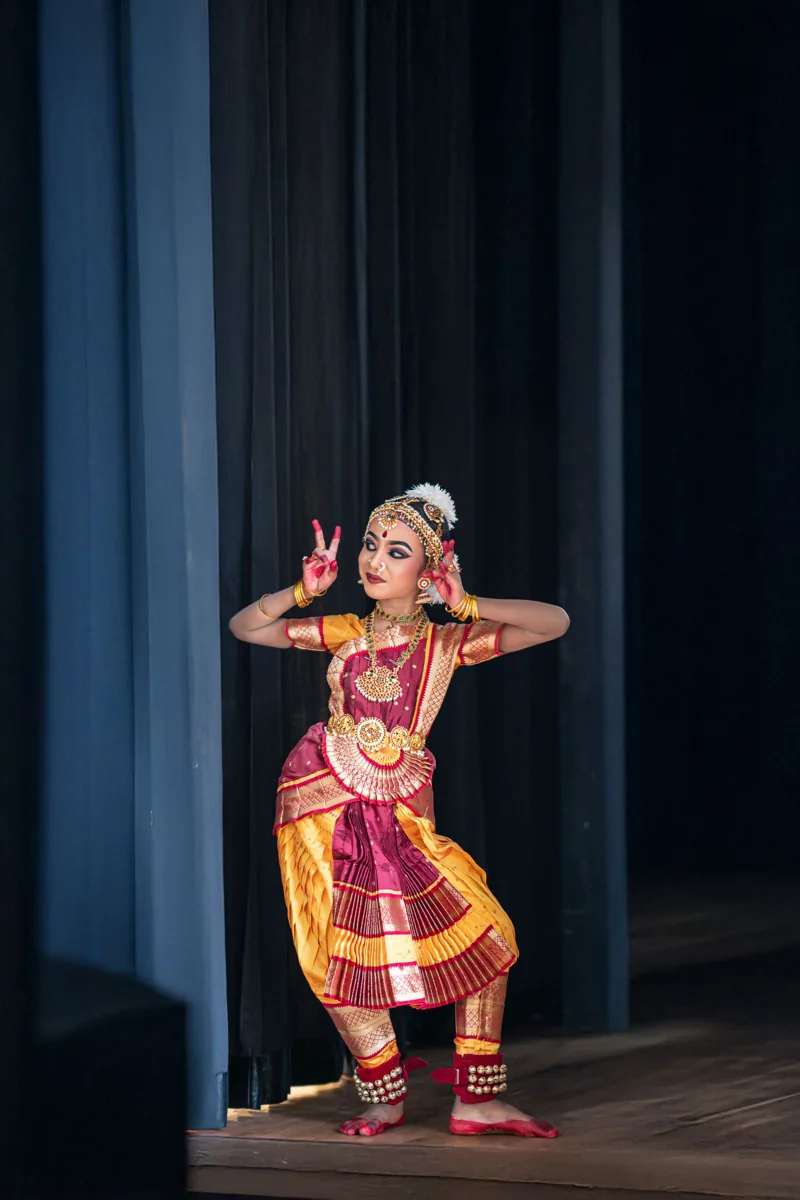 Young dancer performing a classical Indian dance on stage